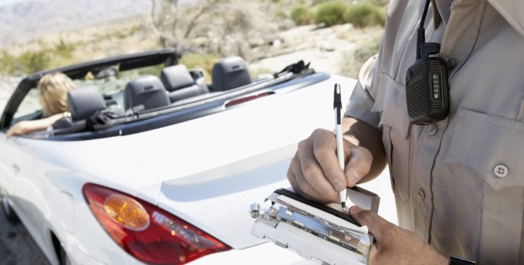 photo of police writing a ticket for reckless driving in VA